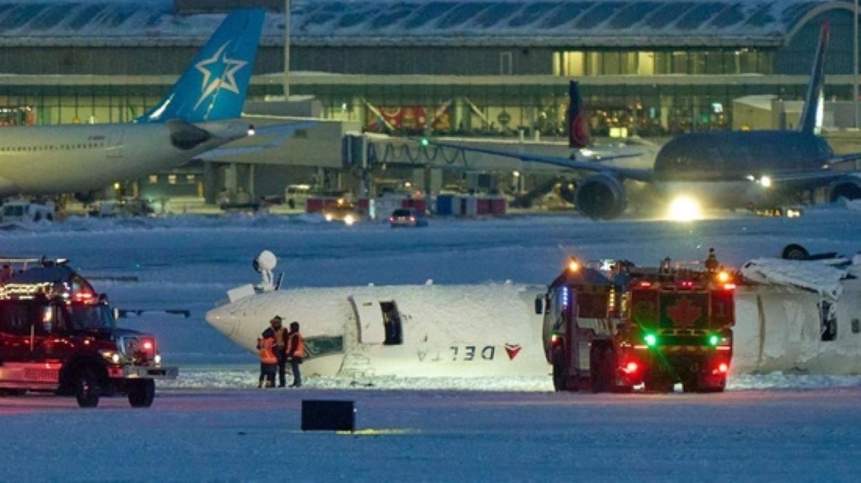 A Delta airlines plane sits on its roof after crashing upon landing at Toronto Pearson Airport in Toronto, Ontario, Canada, on Monday