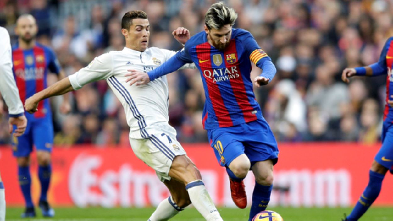 ionel Messi, center right, escapes Cristiano Ronaldo during the Spanish La Liga soccer match between FC Barcelona and Real Madrid at the Camp Nou in Barcelona, Spain, Saturday, Dec. 3, 2016